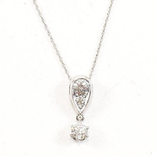 21 - A 14ct white gold and diamond pendant necklace. The necklace strung with a diamond drop pendant. The... 