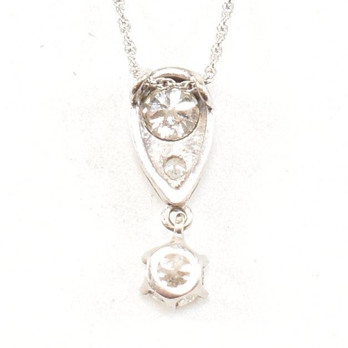 21 - A 14ct white gold and diamond pendant necklace. The necklace strung with a diamond drop pendant. The... 