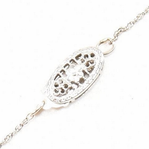 21 - A 14ct white gold and diamond pendant necklace. The necklace strung with a diamond drop pendant. The... 