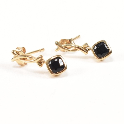 258 - A hallmarked 9ct gold band ring together with a pair of 9ct gold and sapphire pendant earrings. The ... 