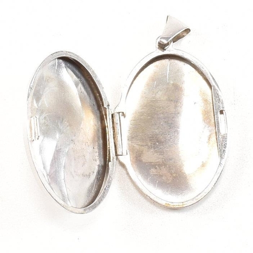 260 - A collection of silver and white metal rings and earrings and pendants. The earrings to include Mack... 