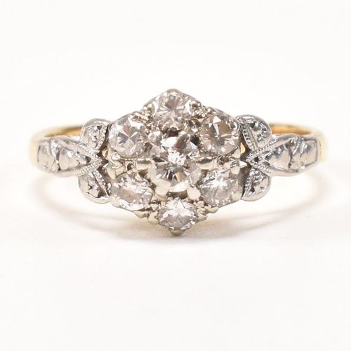 296 - An 18ct gold and diamond cluster ring. The ring having a central round brilliant cut diamond surroun... 