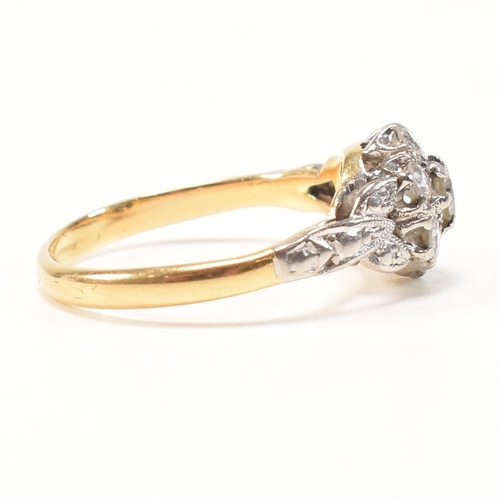 296 - An 18ct gold and diamond cluster ring. The ring having a central round brilliant cut diamond surroun... 
