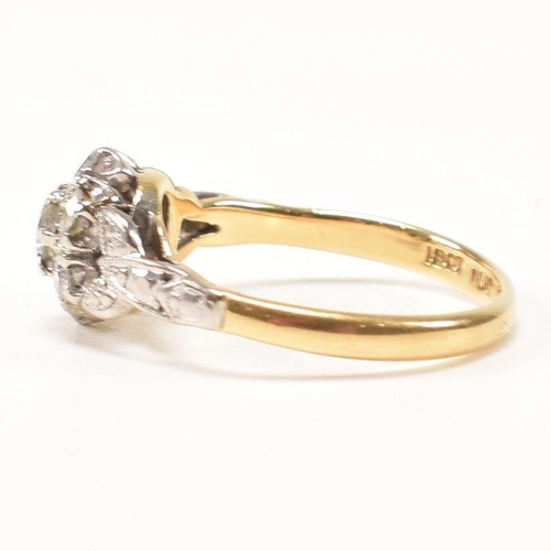296 - An 18ct gold and diamond cluster ring. The ring having a central round brilliant cut diamond surroun... 