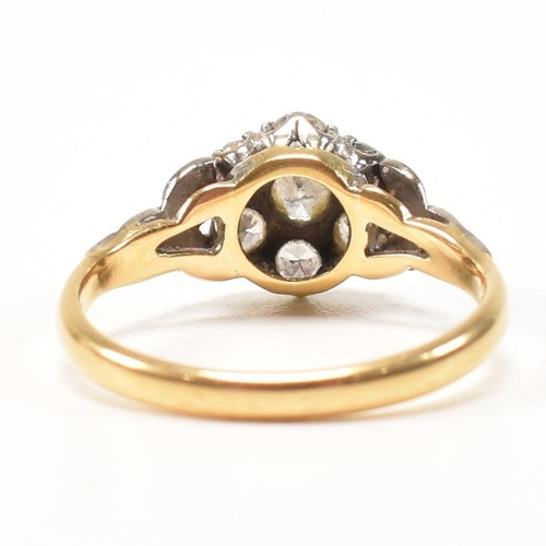 296 - An 18ct gold and diamond cluster ring. The ring having a central round brilliant cut diamond surroun... 