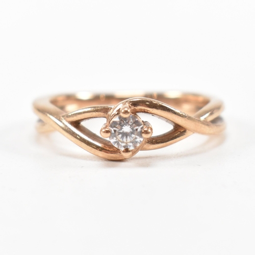 297 - A hallmarked 9ct rose gold and white stone solitaire crossover ring. The single stone engagement sty... 