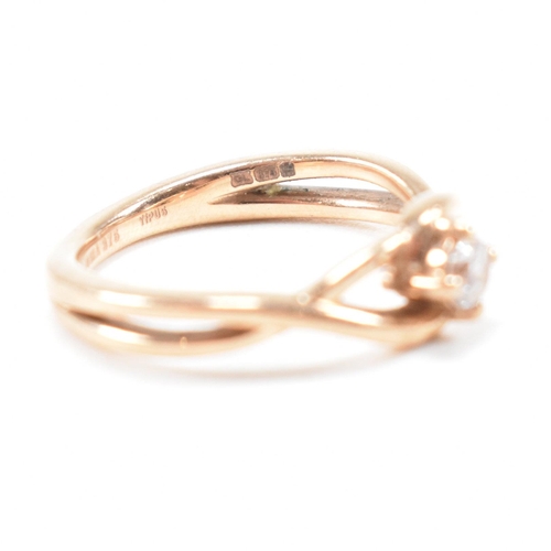 297 - A hallmarked 9ct rose gold and white stone solitaire crossover ring. The single stone engagement sty... 