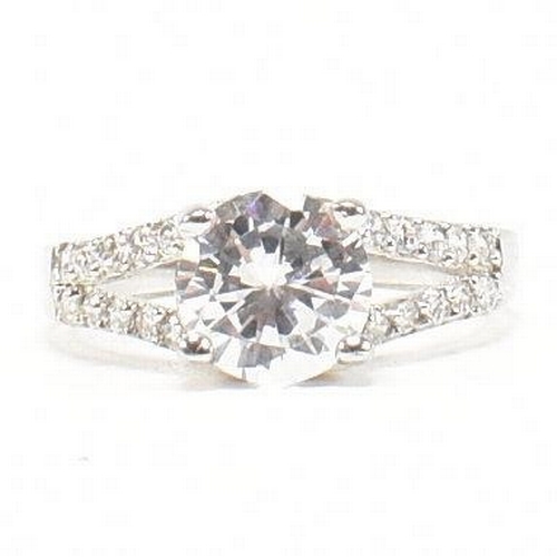 362 - A pair of 925 silver and CZ rings. The rings to include a 925 silver and CZ engagement style ring, s... 