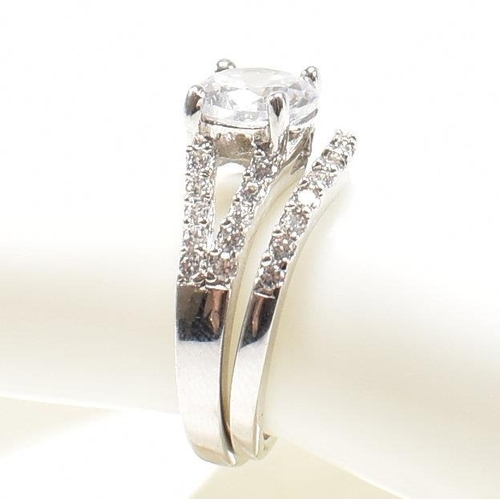 362 - A pair of 925 silver and CZ rings. The rings to include a 925 silver and CZ engagement style ring, s... 