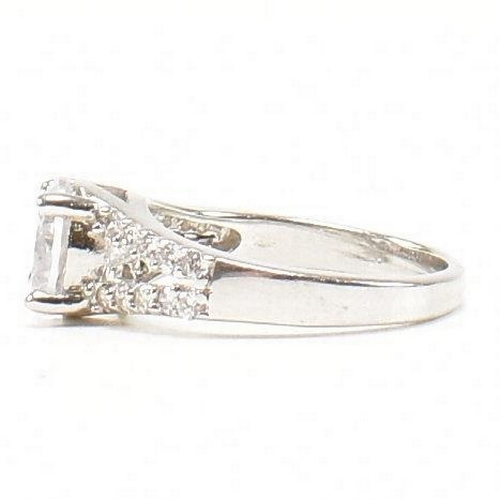 362 - A pair of 925 silver and CZ rings. The rings to include a 925 silver and CZ engagement style ring, s... 