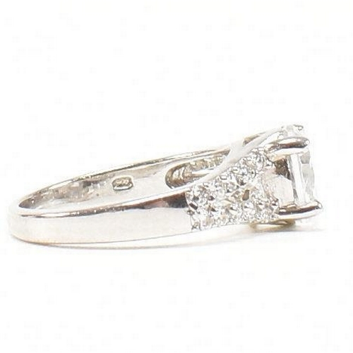 362 - A pair of 925 silver and CZ rings. The rings to include a 925 silver and CZ engagement style ring, s... 