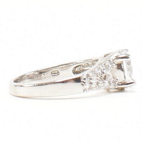 362 - A pair of 925 silver and CZ rings. The rings to include a 925 silver and CZ engagement style ring, s... 