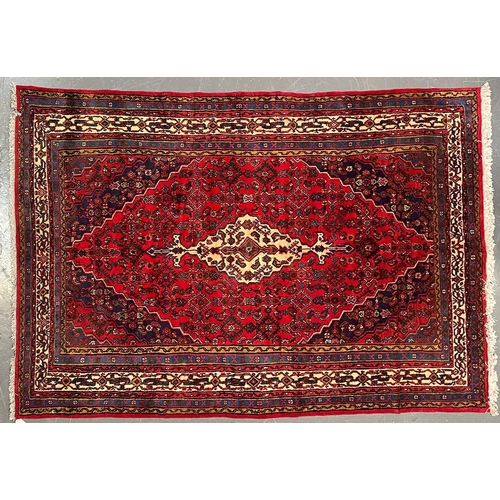 386 - An early 20th century North West Persian Islamic Hamadan floor carpet rug. The rug having a a centra... 