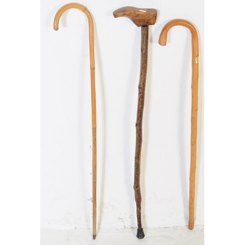 199 - A collection of vintage 20th century and later wooden walking sticks / swagger canes. Two examples o... 