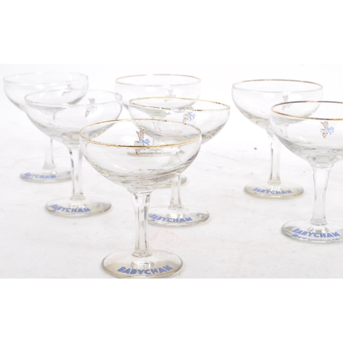 32 - Babycham - A collection of eight mid 20th century Babycham coupe glasses. Each glass having a gilt e... 