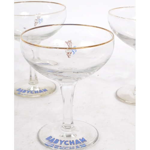 32 - Babycham - A collection of eight mid 20th century Babycham coupe glasses. Each glass having a gilt e... 