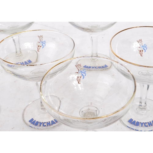 32 - Babycham - A collection of eight mid 20th century Babycham coupe glasses. Each glass having a gilt e... 