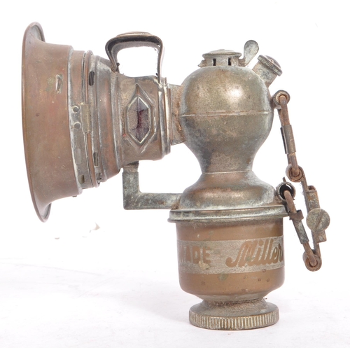 352 - An early 20th century Miller Regalite cycle lamp. The lamp having a large convex lens with hood to f... 