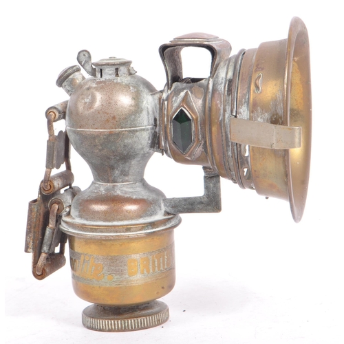 352 - An early 20th century Miller Regalite cycle lamp. The lamp having a large convex lens with hood to f... 