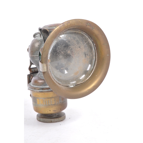 352 - An early 20th century Miller Regalite cycle lamp. The lamp having a large convex lens with hood to f... 