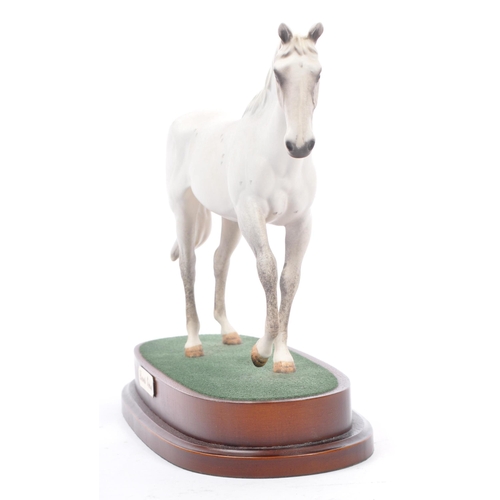 107 - Royal Doulton - A vintage 20th century porcelain china statue of a horse. Titled desert orchid. In a... 