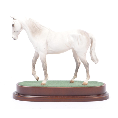 107 - Royal Doulton - A vintage 20th century porcelain china statue of a horse. Titled desert orchid. In a... 