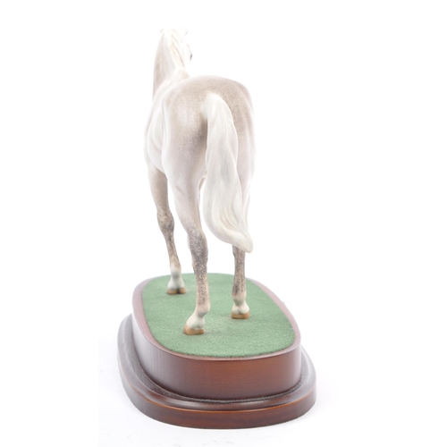 107 - Royal Doulton - A vintage 20th century porcelain china statue of a horse. Titled desert orchid. In a... 