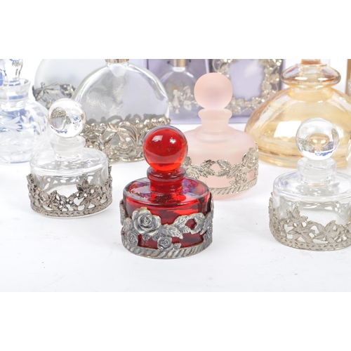 134 - A large collection of vintage perfume and fragrance bottles, with some cut glass examples. The major... 