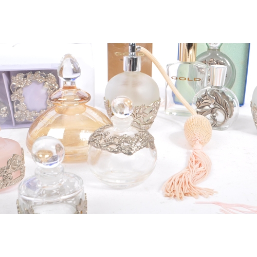 134 - A large collection of vintage perfume and fragrance bottles, with some cut glass examples. The major... 