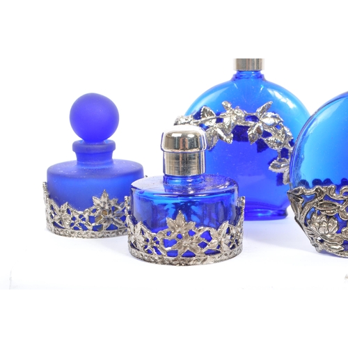 134 - A large collection of vintage perfume and fragrance bottles, with some cut glass examples. The major... 