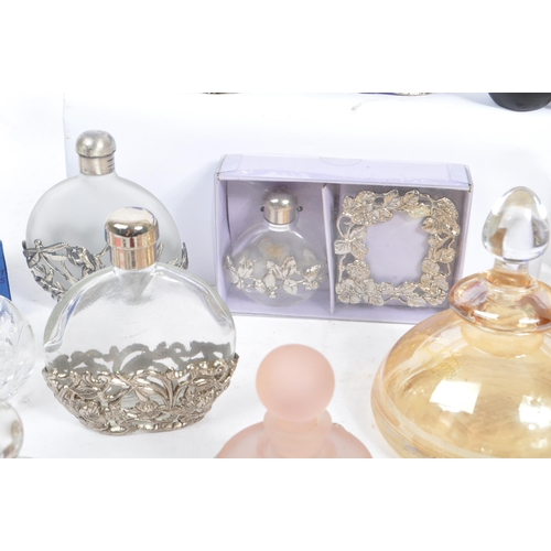 134 - A large collection of vintage perfume and fragrance bottles, with some cut glass examples. The major... 