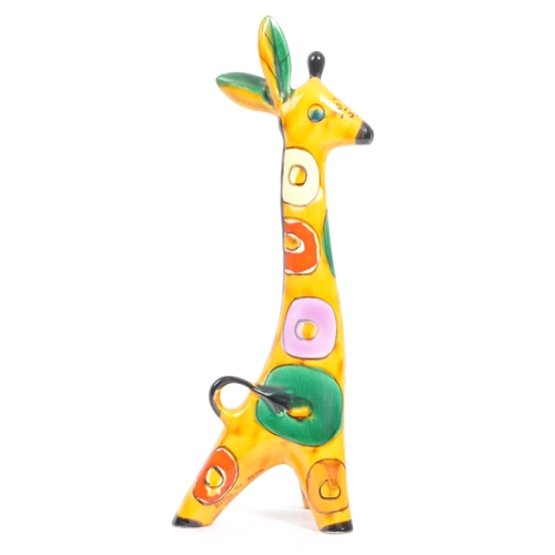 146 - A 1960s Lomonosov USSR ceramic figure / figurine of a giraffe. With multicoloured geometric patterns... 