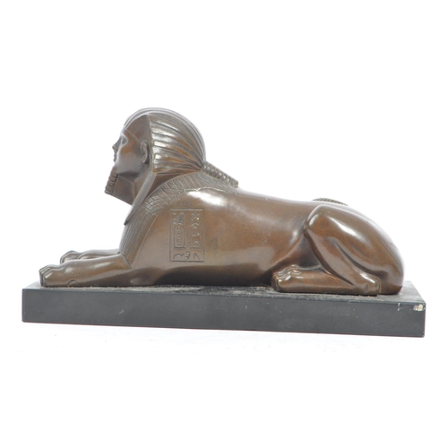 183 - An Egyptian Revival late Victorian early 20th century circa 1900 cast bronze figure of Sphinx. The f... 