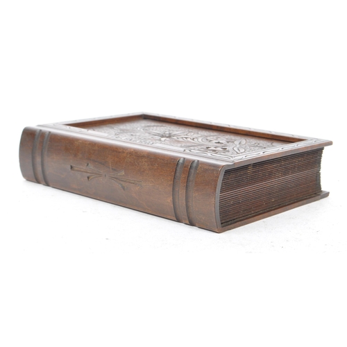 187 - A Continental Black Forest early 20th century wooden two tier cigarette case in the shape of a book.... 