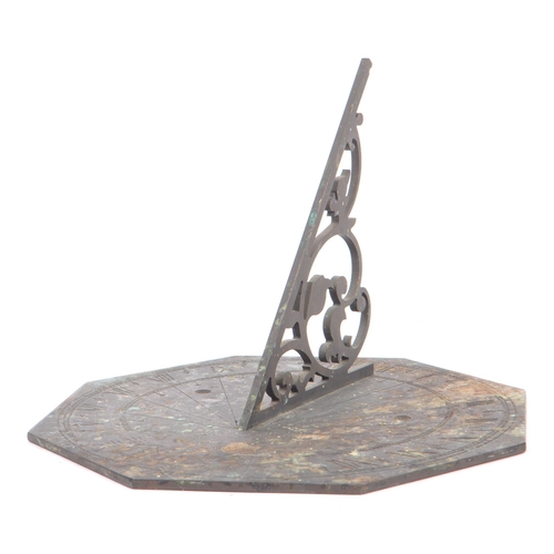 188 - A late 19th century / early 20th century bronze octagonal table desk sundial. The dial having a pier... 