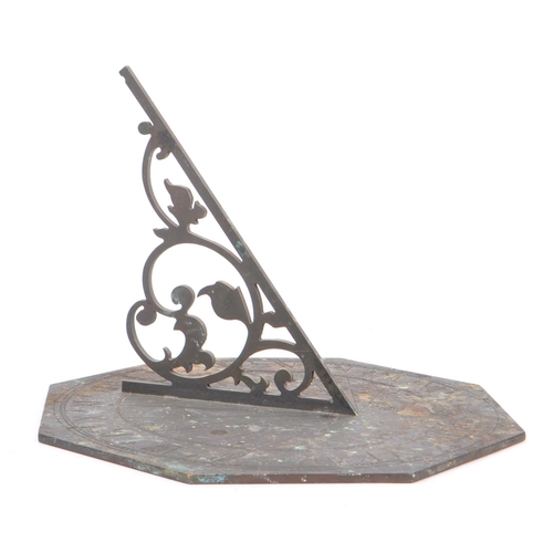 188 - A late 19th century / early 20th century bronze octagonal table desk sundial. The dial having a pier... 