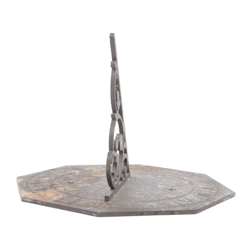 188 - A late 19th century / early 20th century bronze octagonal table desk sundial. The dial having a pier... 