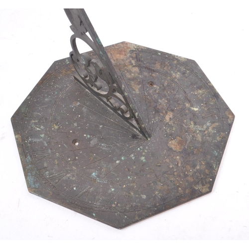 188 - A late 19th century / early 20th century bronze octagonal table desk sundial. The dial having a pier... 