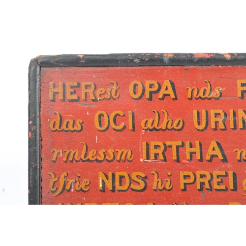 191 - A small and unusual early 20th Century hand carved and painted panel sign. In a black and red colour... 