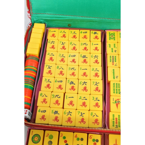 193 - A vintage 20th century Chinese Mahjong domino game set. The set featuring yellow tiles alongside a s... 