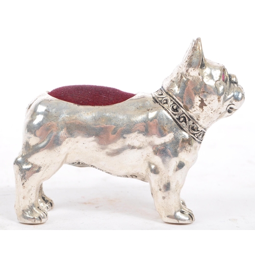 205 - A vintage mid 20th century French Bulldog pin cushion. In a standing position with purple material a... 