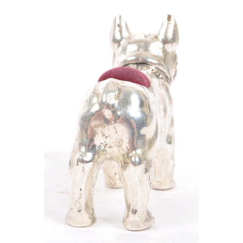 205 - A vintage mid 20th century French Bulldog pin cushion. In a standing position with purple material a... 