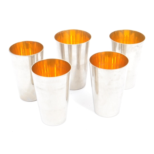 214 - A set of six 20th century silver plated graduating travel cups in leather case, alongside a stainles... 