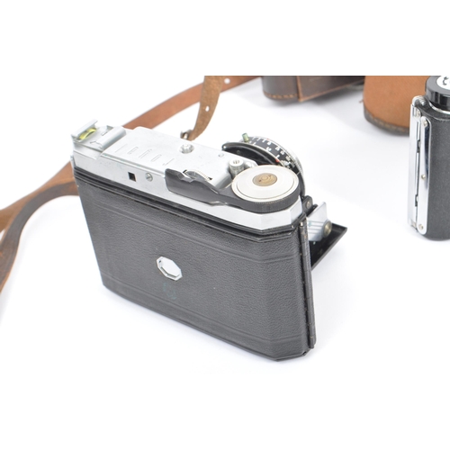 219 - A mid 20th century circa 1960s Minolta AF 35mm rangefinder camera alongside other 20th century camer... 