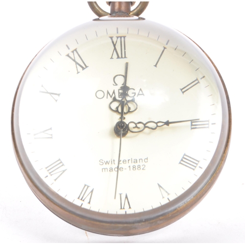 220 - Omega - Switzerland - A late 19th century table desk clock. With a white face, black roman numeral c... 