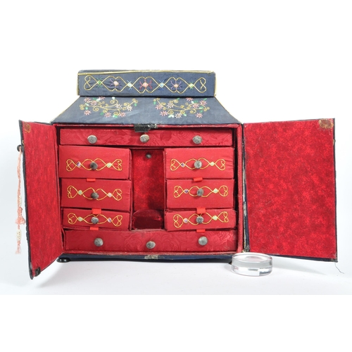 226 - A 1920s Chinese embroidered twin swing door sewing box. Having independant lidded box atop, embroide... 