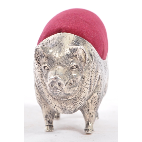 227 - A vintage 20th century large pin cushion on the form of an English pig / swine. With burgundy materi... 