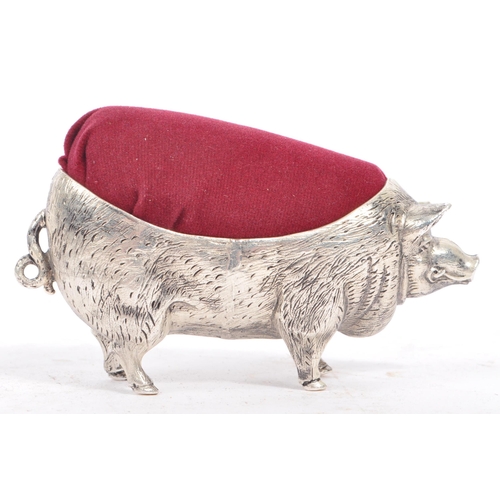 227 - A vintage 20th century large pin cushion on the form of an English pig / swine. With burgundy materi... 