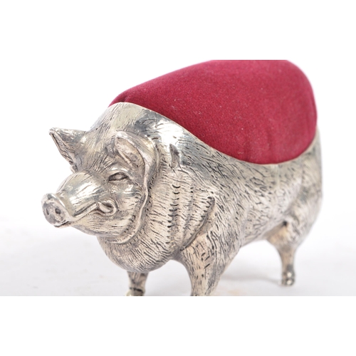 227 - A vintage 20th century large pin cushion on the form of an English pig / swine. With burgundy materi... 