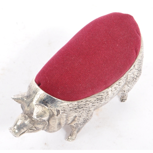 227 - A vintage 20th century large pin cushion on the form of an English pig / swine. With burgundy materi... 